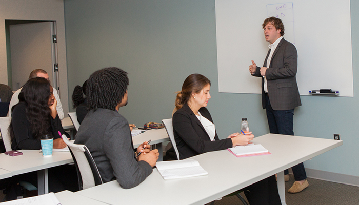 CEO Zack Shuch leads business education meeting